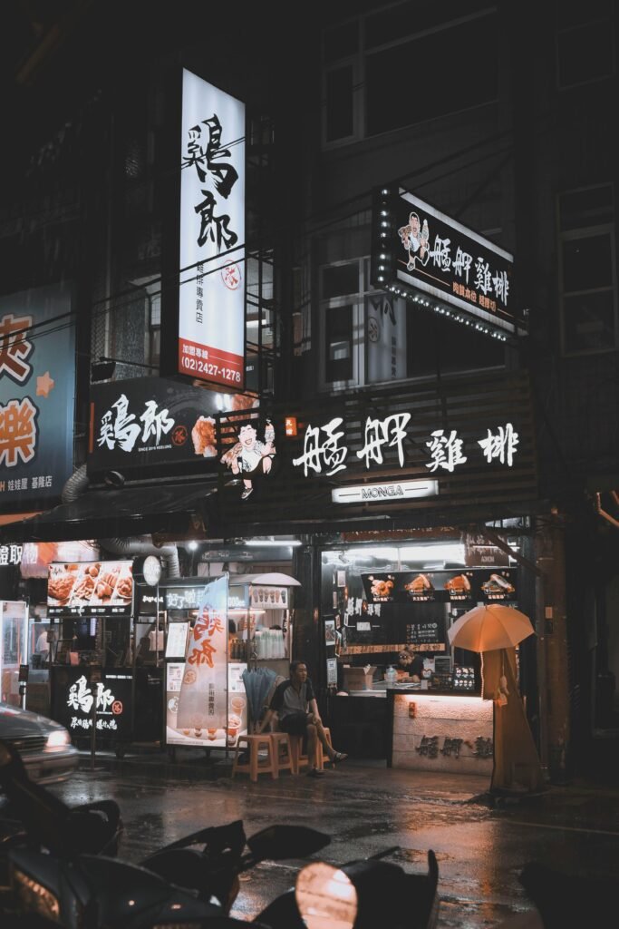 Illuminated food stalls and street life at night in Ren’ai District, Taiwan.